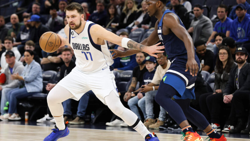 Dallas Mavericks guard Luka Doncic tries to dribble around Minnesota Timberwolves guard Anthony Edwards