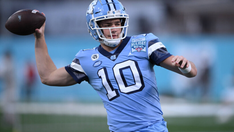Drake Maye warms up for the Holiday Bowl.