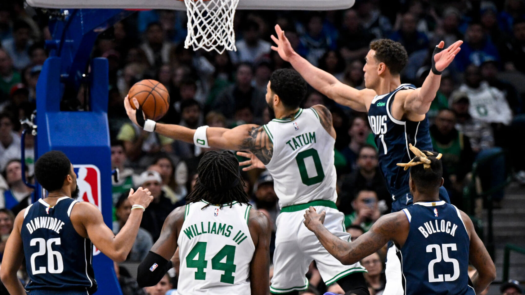 Boston Celtics forward Jayson Tatum goes for a layup against Dallas Mavericks defenders