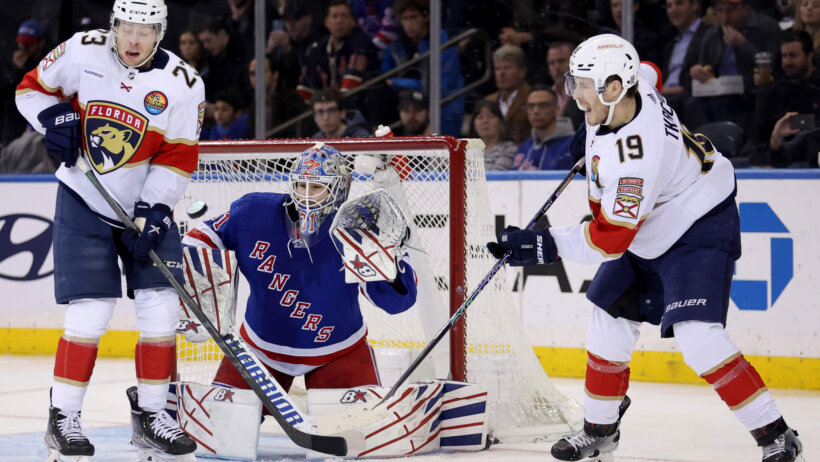 New York Rangers goaltender Igor Shesterkin (31) plays the puck against Florida Panthers center Carter Verhaeghe (23) and left wing Matthew Tkachuk (19)