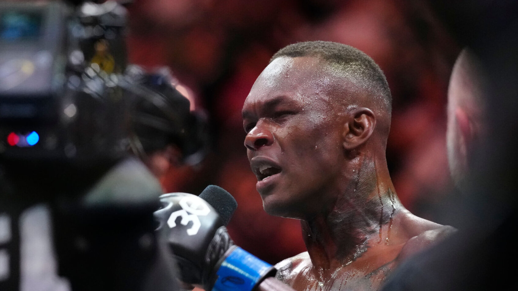 Israel Adesanya post fight interview holding mic