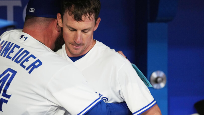 Toronto Blue Jays manager John Schneider hugging starting pitcher Chris Bassitt