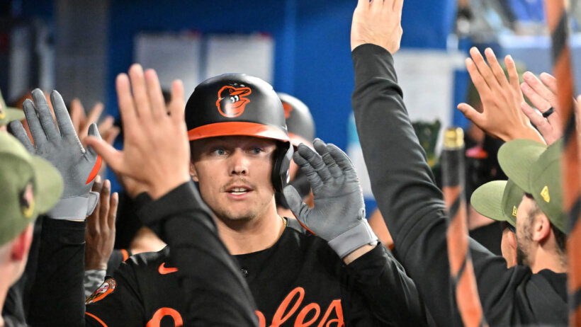 Baltimore Orioles first baseman Ryan Mountcastle high-fiving teammates