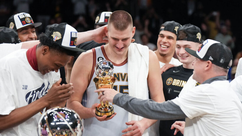 Nikola Jokic celebrating with his Denver Nuggets teammates.
