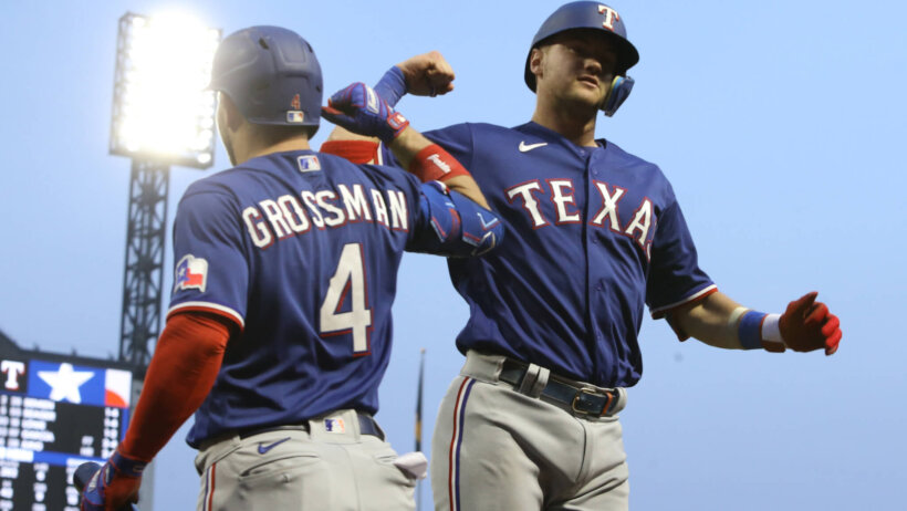 Texas Rangers left fielder Robbie Grossman celebrates with Josh Jung