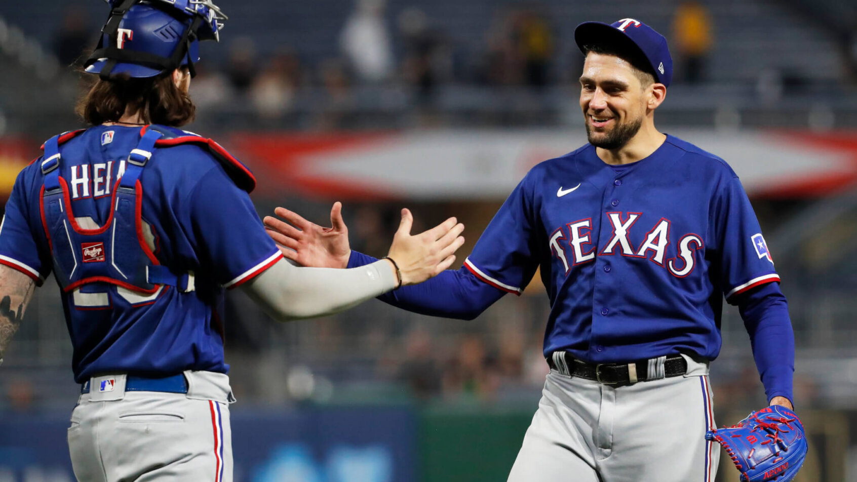 Texas Rangers catcher Jonah Heim and pitcher Nathan Eovaldi celebrate a win
