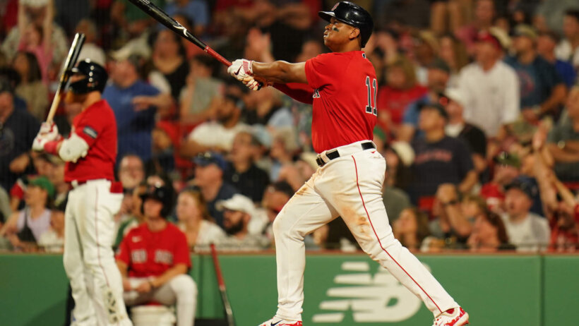 Boston Red Sox third baseman Rafael Devers hitting a double