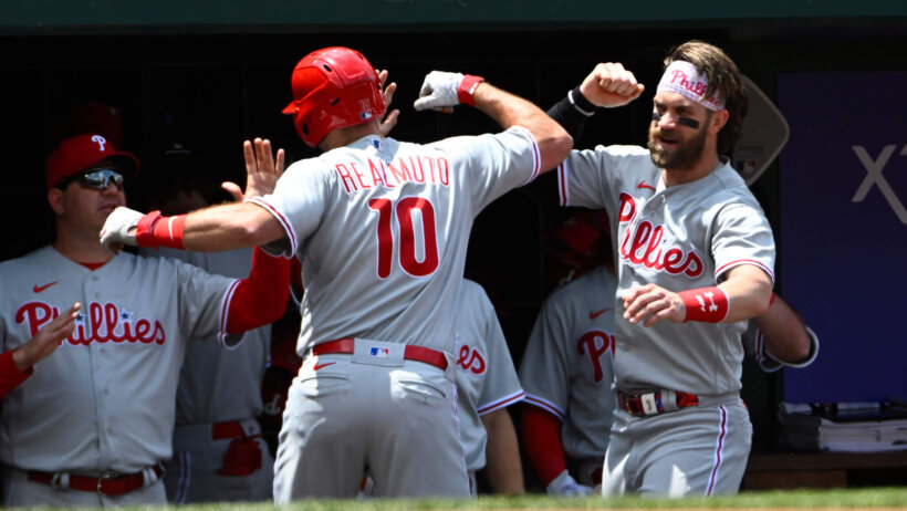 Philadelphia Phillies players celebrate a home run in the dugout