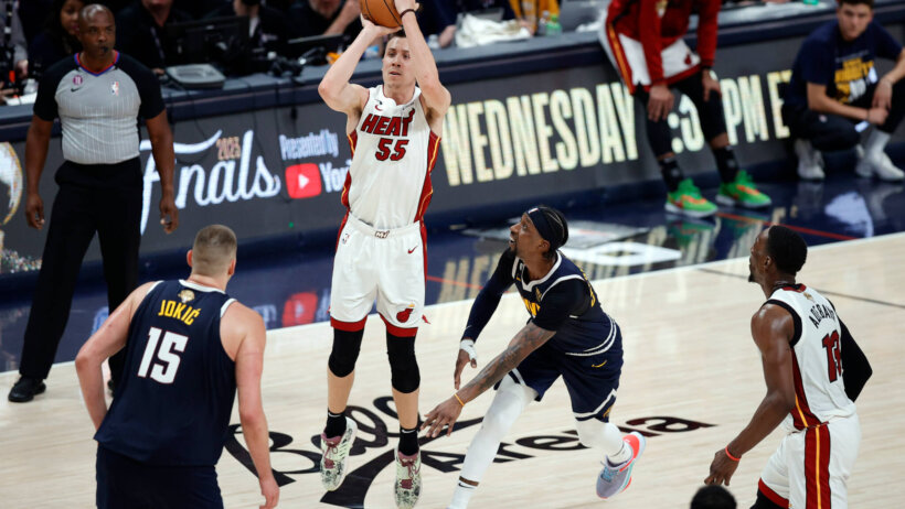 Miami Heat guard Duncan Robinson facing Denver Nuggets defenders in the NBA Finals.