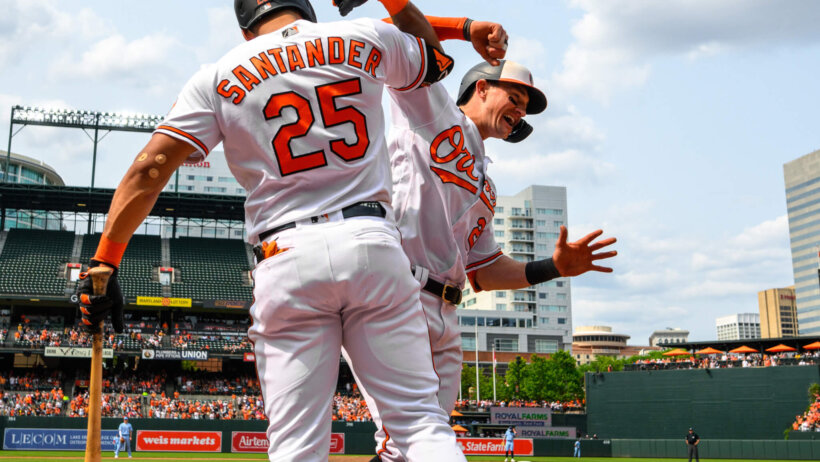 Austin Hays celebrates with Anthony Santander