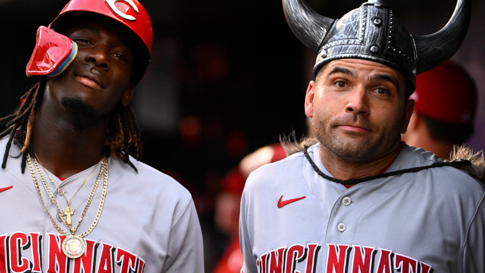 Joey Votto and Elly De La Cruz posing in the dugout