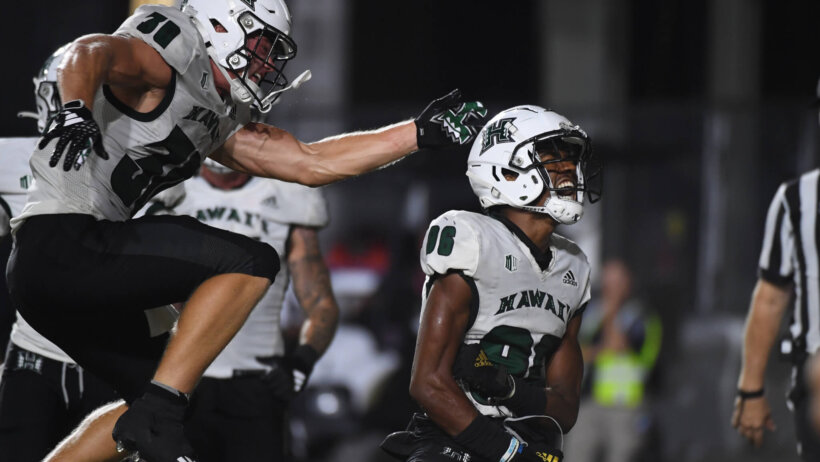 Hawaii Warriors wide receiver Pofele Ashlock celebrates with running back Landon Sims after a touchdown