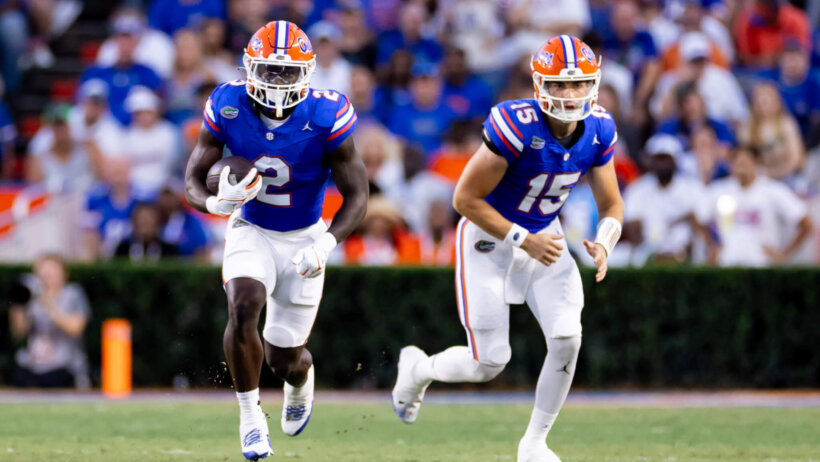 Florida Gators running back Montrell Johnson Jr. rushes with the ball after a handoff from Florida Gators quarterback Graham Mertz