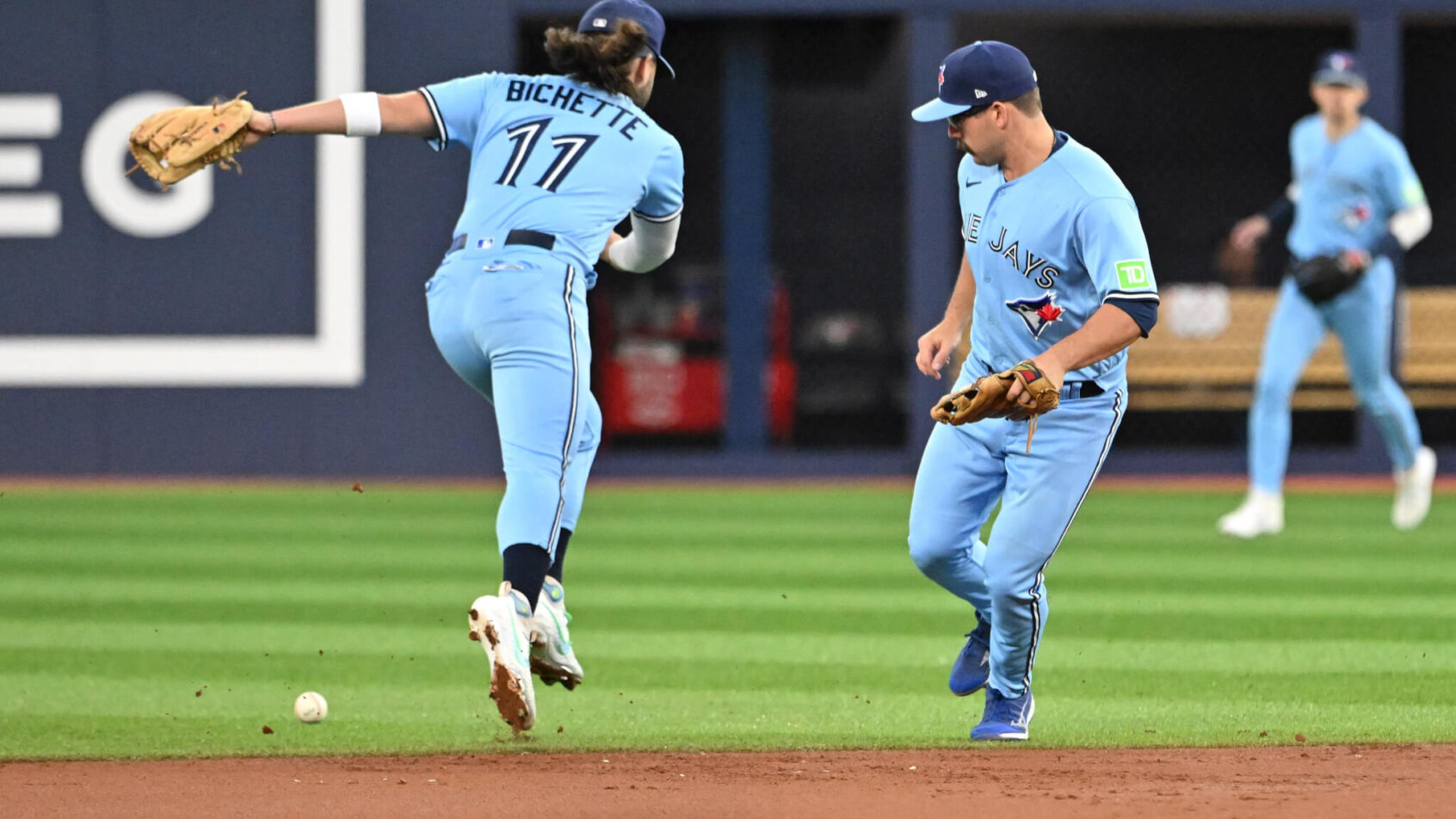 Toronto Blue Jays shortstop Bo Bichette and second baseman Davis Schneider misplay a ball