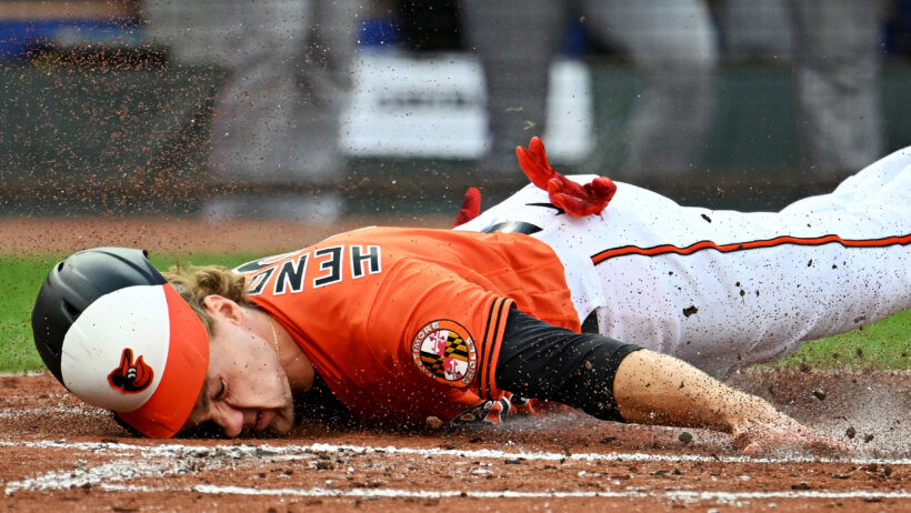 Baltimore Orioles third baseman Gunnar Henderson sliding into home