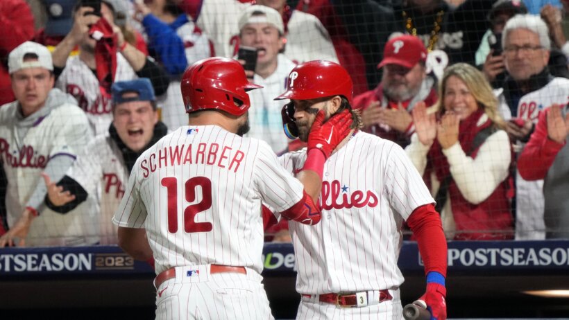 Philadelphia Phillies Kyle Schwarber and Bryce Harper celebrate a home run