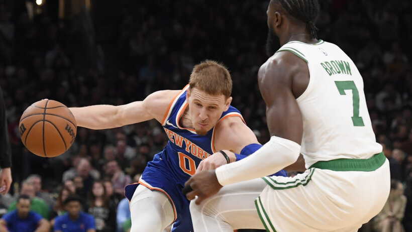 New York Knicks guard Donte DiVincenzo drives against Boston Celtics guard Jaylen Brown