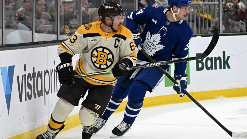 Boston Bruins left wing Brad Marchand skates against Toronto Maple Leafs defenseman Morgan Rielly