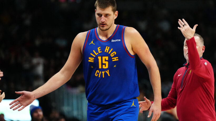 Denver Nuggets center Nikola Jokic high-fives teammates