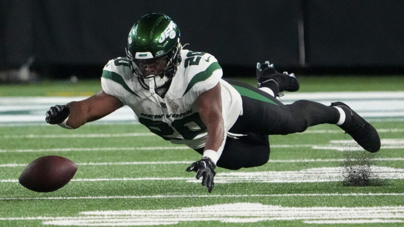 New York Jets running back Breece Hall dives after a fumble