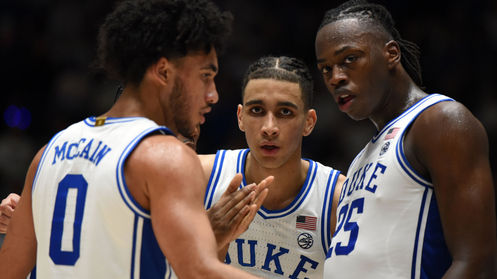 Duke Blue Devils players huddling on the court
