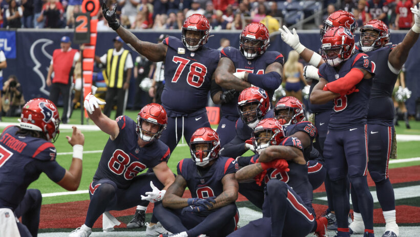 Houston Texans quarterback C.J. Stroud (7) celebrates the Texans touchdown by taking a picture of the offense