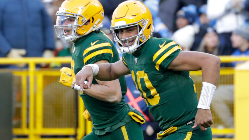 Green Bay Packers quarterback Jordan Love and wide receiver Christian Watson running off the field