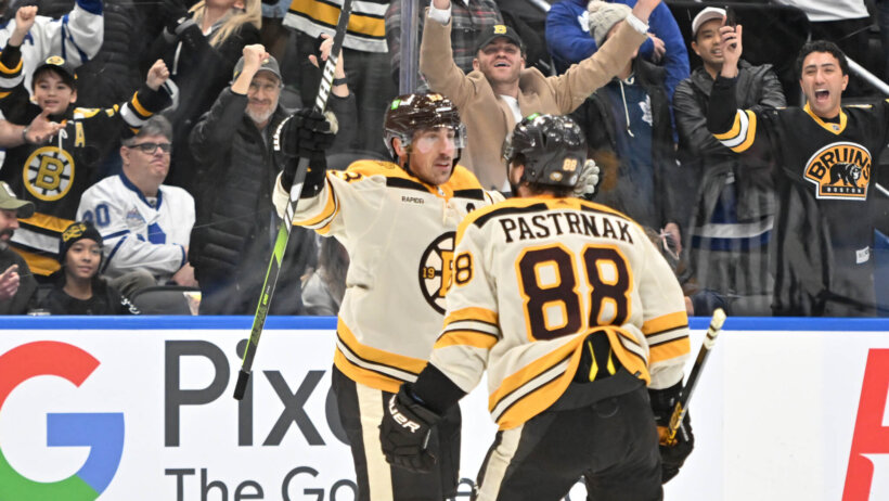 Boston Bruins forward Brad Marchand celebrates with forward David Pastrnak against Toronto Maple Leafs
