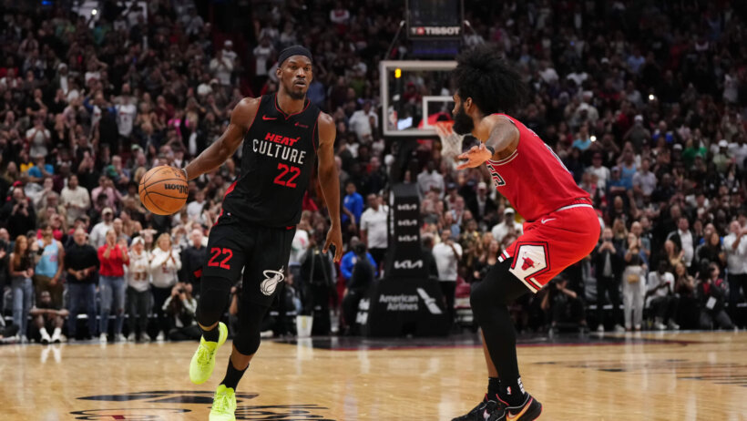 Miami Heat forward Jimmy Butler dribbles against Chicago Bulls guard Coby White