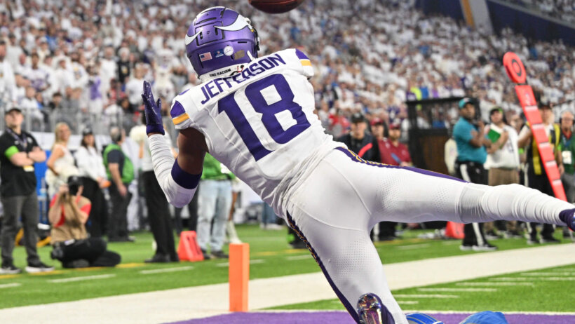 Minnesota Vikings wide receiver Justin Jefferson (18) catches a touchdown pass from quarterback Nick Mullens