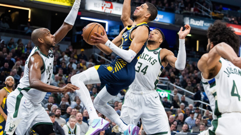 Indiana Pacers guard Tyrese Haliburton drives against several Milwaukee Bucks defenders