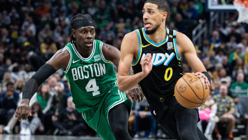 Indiana Pacers guard Tyrese Haliburton dribbles past Boston Celtics guard Jrue Holiday