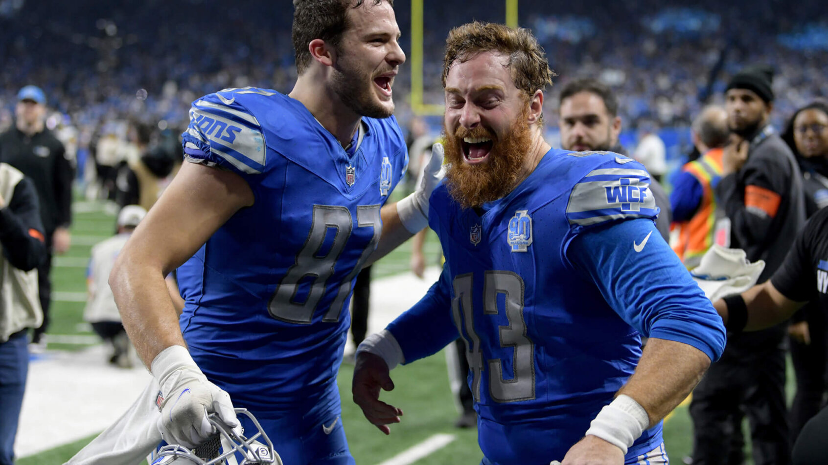 Detroit Lions tight end Sam LaPorta (87) and long snapper Jake McQuaide (43) celebrate after a 2024 NFC wild card game against the Los Angeles Rams