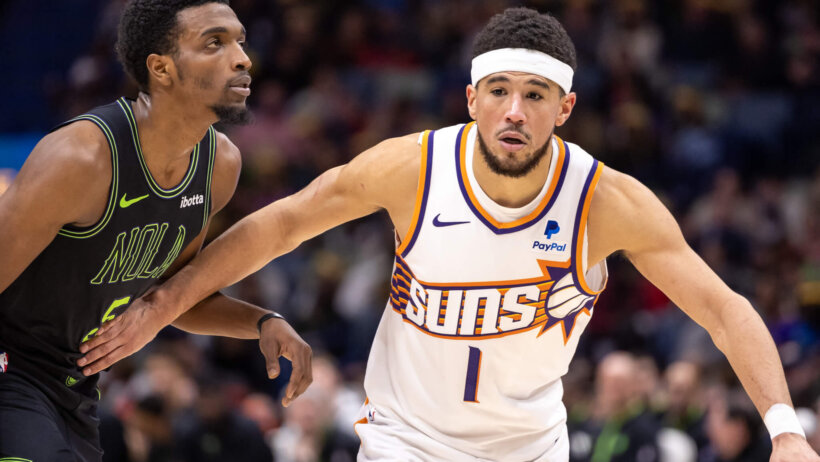 Phoenix Suns guard Devin Booker battles with New Orleans Pelicans forward Herbert Jones