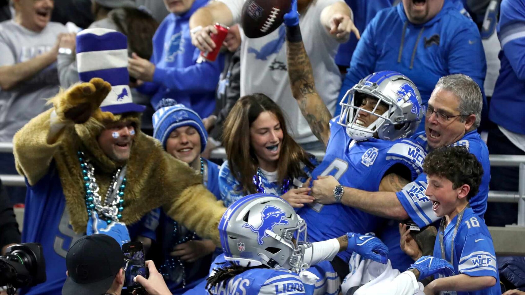 Detroit Lions wide receiver Josh Reynolds celebrates with fans