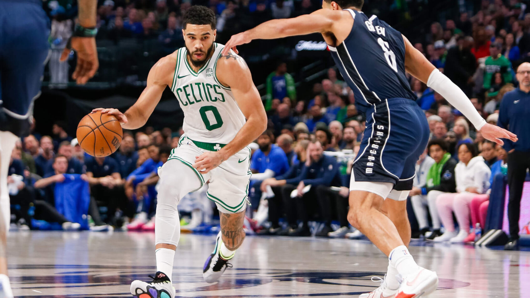 Boston Celtics forward Jayson Tatum drives at Dallas Mavericks guard Josh Green