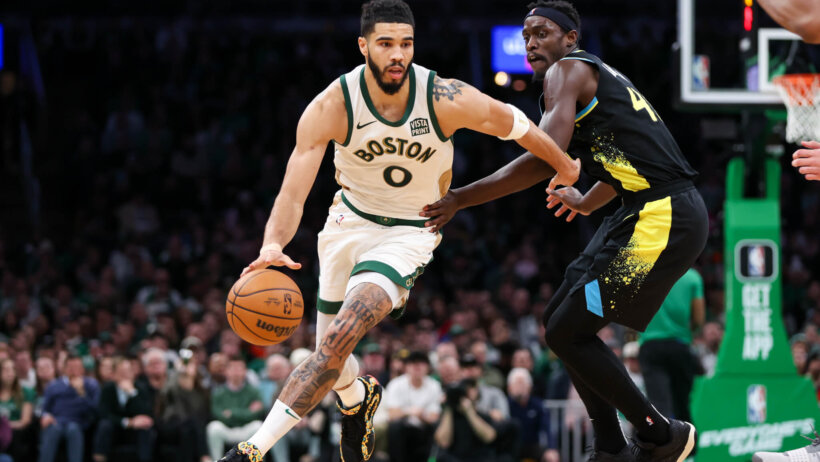 Boston Celtics forward Jayson Tatum dribbles past Indiana Pacers forward Pascal Siakam