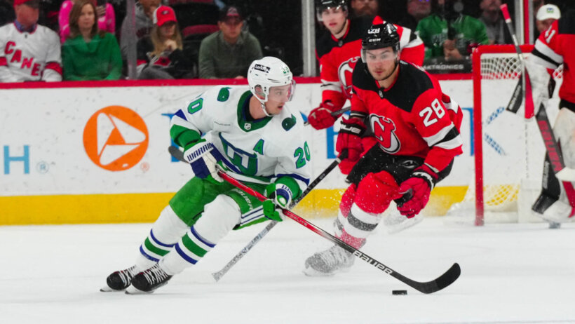 Carolina Hurricanes center Sebastian Aho skates with the puck against New Jersey Devils right wing Timo Meier