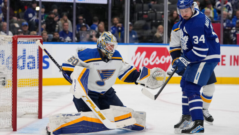 Toronto Maple Leafs forward Auston Matthews tries to deflect a puck against St. Louis Blues goaltender Jordan Binnington