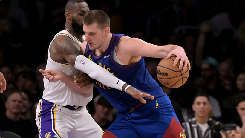 Los Angeles Lakers forward LeBron James guards Denver Nuggets center Nikola Jokic