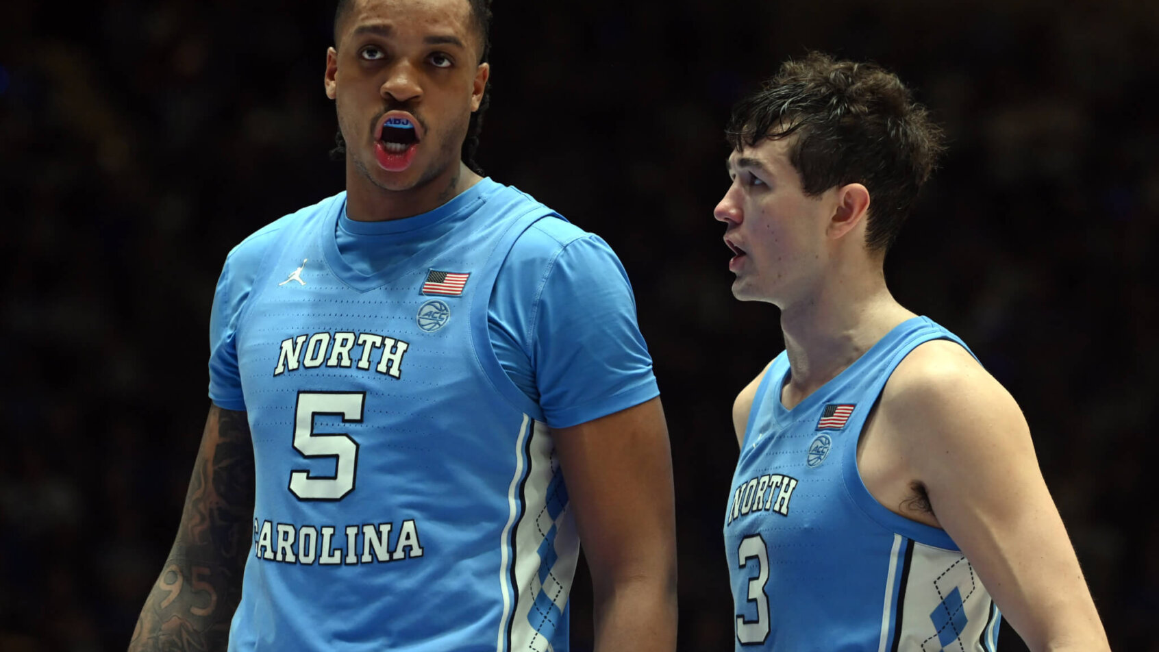 UNC Tar Heels Players talking mid game blue jerseys