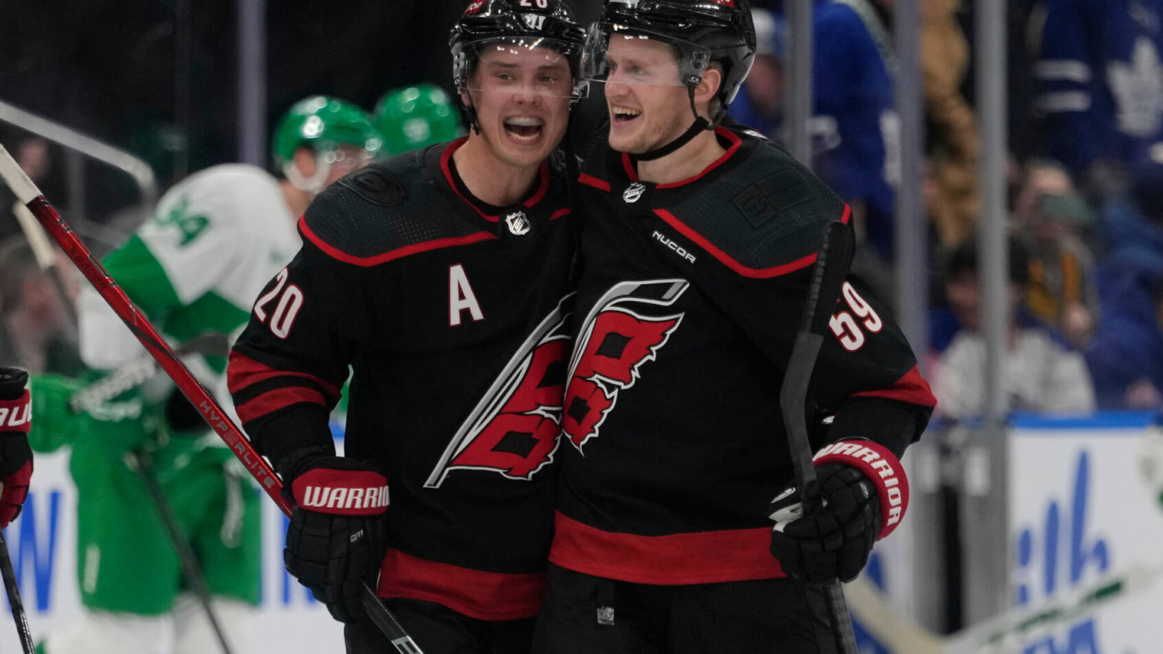 Carolina Hurricanes forward Sebastian Aho congratulates forward Jake Guentzel