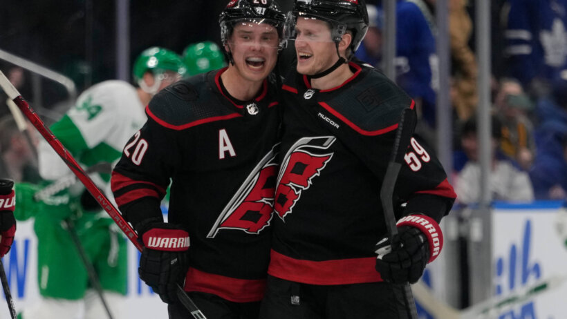 Carolina Hurricanes forward Sebastian Aho congratulates forward Jake Guentzel