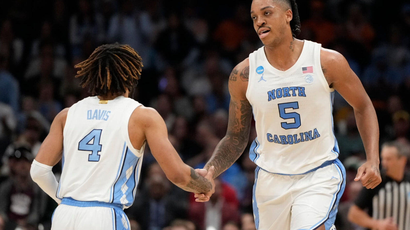 North Carolina Tar Heels forward Armando Bacot low-fives guard RJ Davis