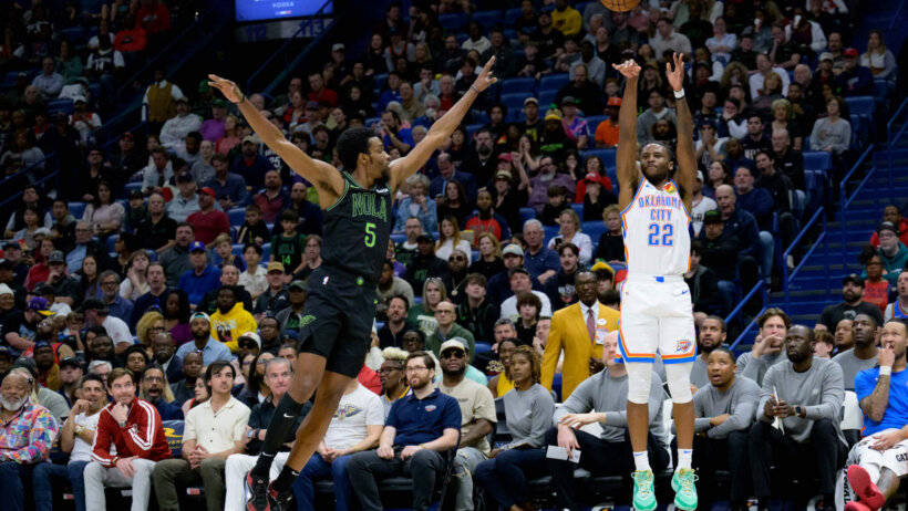 Oklahoma City Thunder guard Cason Wallace shoots a three over New Orleans Pelicans forward Herbert Jones