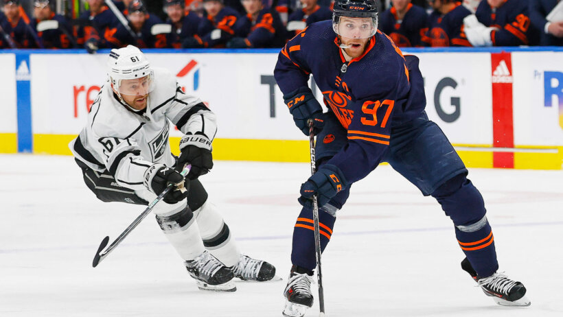 Edmonton Oilers forward Connor McDavid looks to make a pass in front of Los Angeles Kings forward Trevor Lewis