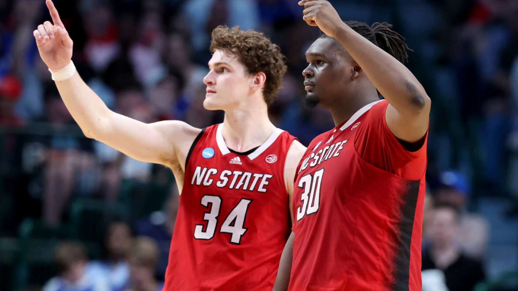 North Carolina State Wolfpack forward Ben Middlebrooks and center DJ Burns Jr gesture to the crowd