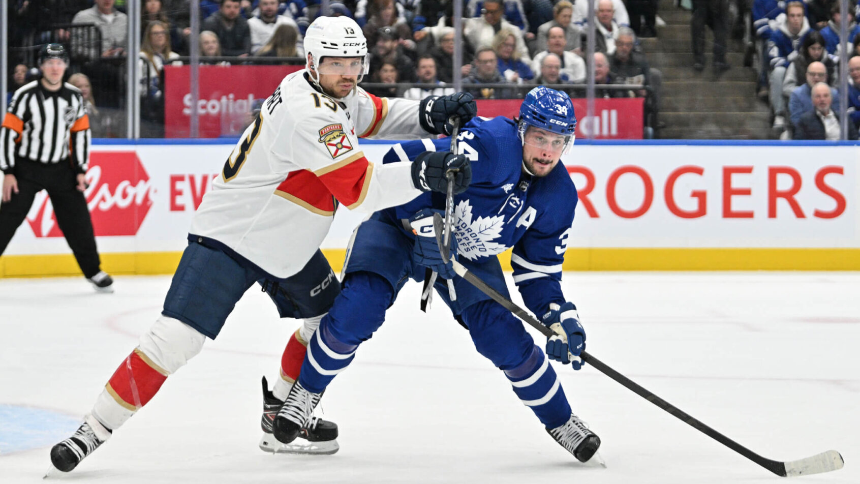 Florida Panthers forward Sam Reinhart pushes on Toronto Maple Leafs forward Auston Matthews
