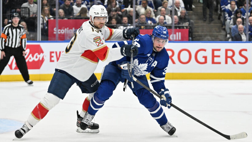Florida Panthers forward Sam Reinhart pushes on Toronto Maple Leafs forward Auston Matthews