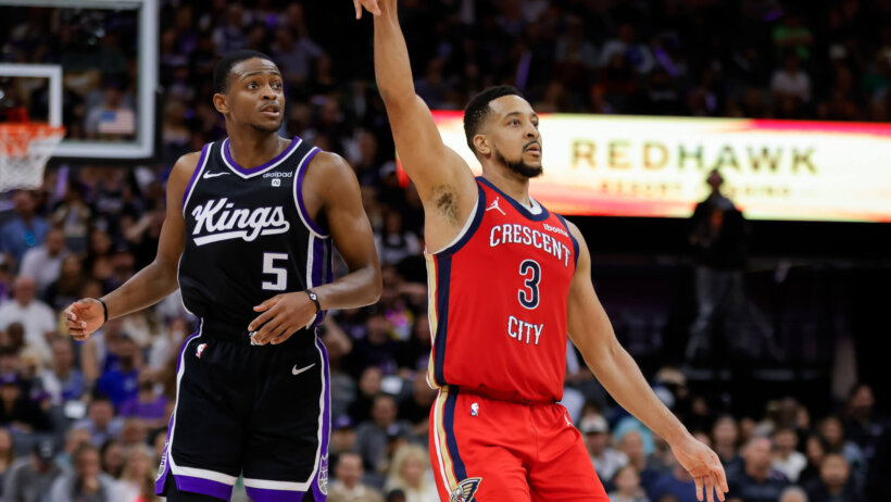 New Orleans Pelicans guard CJ McCollum strikes a pose after hitting a three